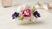 Bridal floral hair claw clip with pink peony rose centre, white calla lily petals, purple berry clusters and green buds on a white slim claw base