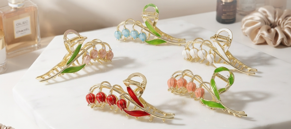 Korean lily of the valley tulip hair claw clips in blush pink, sky blue, ivory white, coral red and peach blush displayed on marble surface with perfume bottle