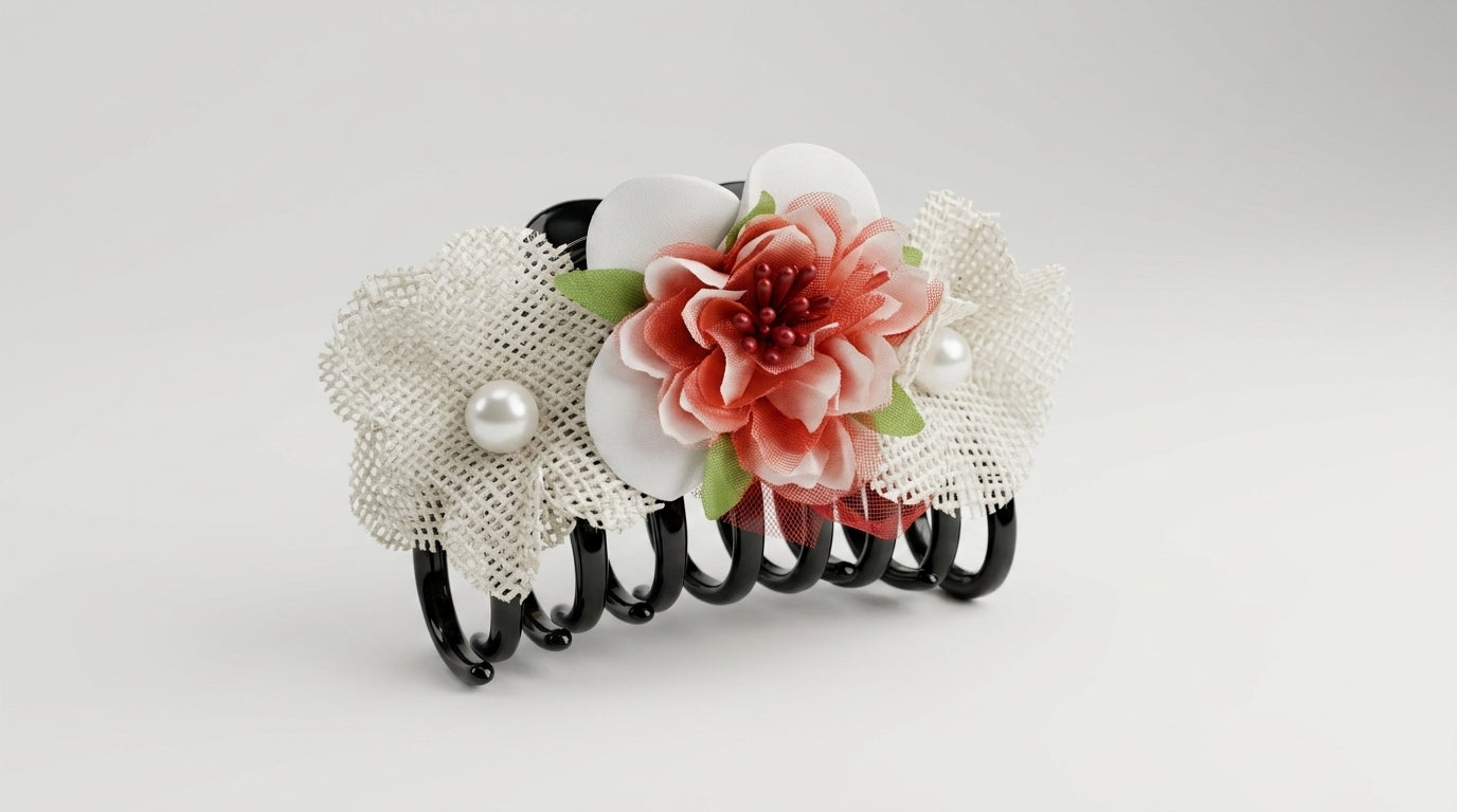 Black coil claw clip with coral dahlia centre, white magnolia petals, two white lace tulle rosettes with pearl centres and green leaf accents on white background